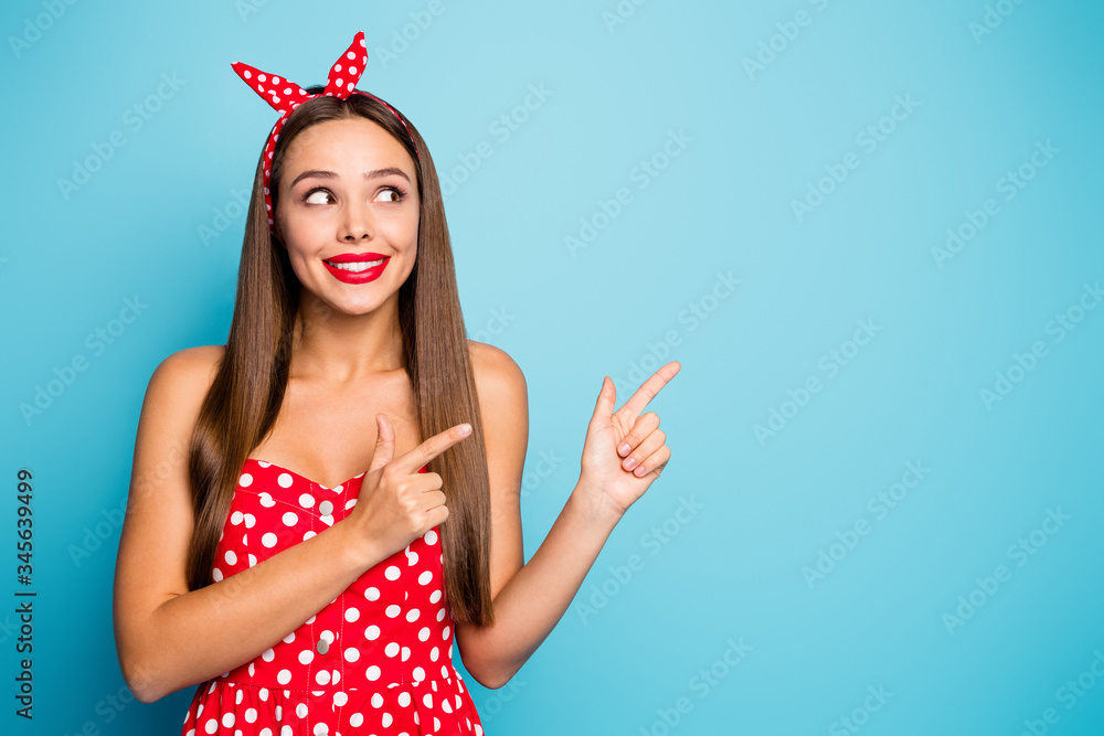 Close-up portrait of nice-looking attractive lovely glamorous curious cheerful cheery straight-haired girl showing new novelty isolated over bright vivid shine vibrant blue color background - obrazy, fototapety, plakaty 