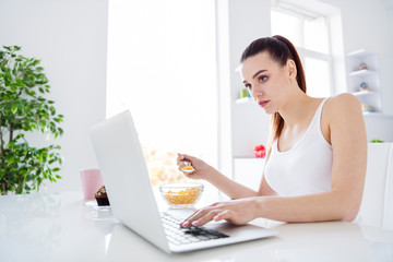 Sticker - Profile photo of charming house wife lady worker sitting morning kitchen browsing notebook freelancer have breakfast eat cereal corn flakes stay home distance remote work quarantine indoors