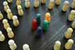 Racism and social exclusion concept. Small group of figures and big one.