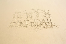 Happy Birthday Hand Written Message On Wet Beach Sand