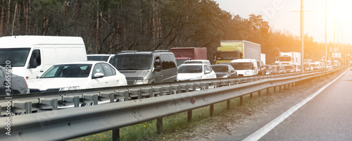Fotografía Highway interstate road with car traffic jam and tree forest on background