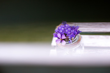 Flores moradas y lilas sobre laminas de madera blanca