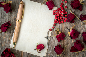 Wall Mural - Religious rosary on blank sheet of paper to write a letter