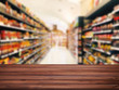 © kongsak - Wood table top with Blurr background in Supermarket store with bokeh