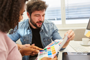 Graphic designer team in choosing colors