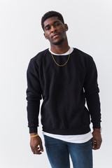 Wall Mural - Youth street fashion concept - Portrait of confident sexy black man in stylish sweatshirt on white background.