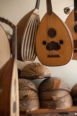 Sticker - Vertical shot of oud musical instruments hanging on the wall