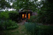 Cottage Style Home With Garden At Dusk