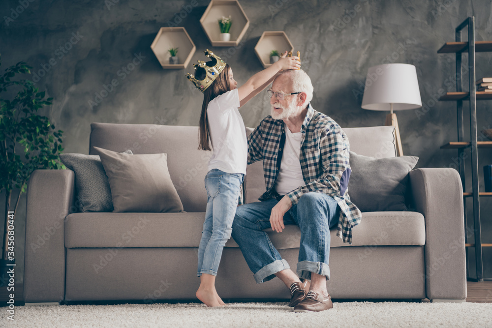 Profile photo of funny aged old grandpa golden crown head little pretty granddaughter playing famous people roles stay home quarantine safety modern interior living room indoors - obrazy, fototapety, plakaty 