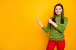 © deagreez - Portrait of charming positive girl point index finger indicate sales news present promotion wear stylish outfit isolated over bright color background
