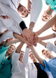 © ASDF - bottom view. a group of medical colleagues putting their hands together.