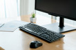 Wireless mouse and keyboard set on top of a wooden office desk,