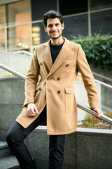 Handsome elegant man taking stairs in a modern city