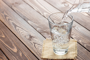 Wall Mural - water pouring from jug into glass