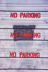 Red No parking lettering on an old white background