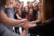 © ASDF - large group of young like-minded people joining their palms