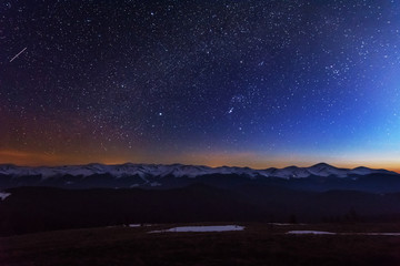Wall Mural - fantastic starry night with galaxy milky way with a tourist and a tent on the mountain range in the 