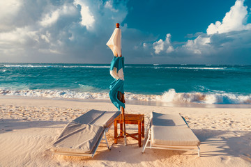 colorful tropical sunset on Anguilla island Caribbean sea with palm trees and ocean waves