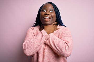 Sticker - African american plus size woman with braids wearing casual sweater over pink background shouting and suffocate because painful strangle. Health problem. Asphyxiate and suicide concept.