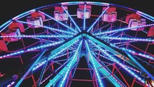 Low Angle View Of Illuminated Ferris Wheel At Night