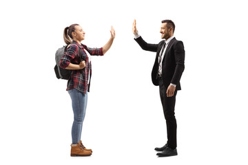 Wall Mural - Female student gesturing high-five with a man in a suit