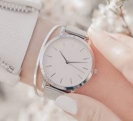 Wall Mural - Stylish fashion watch on woman hand. Close-up photo.