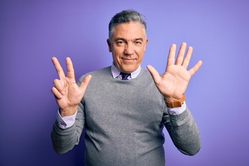 Wall Mural - Middle age handsome grey-haired man wearing elegant sweater over purple background showing and pointing up with fingers number eight while smiling confident and happy.