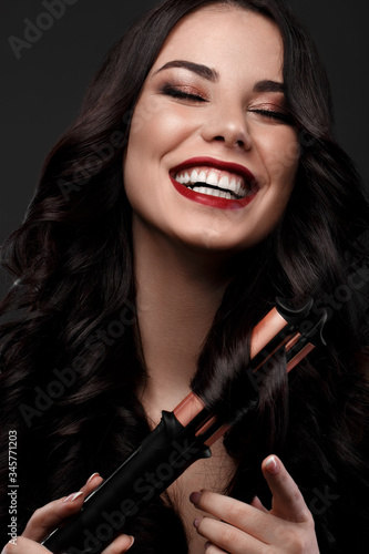 Beautiful brunette model: curls, classic makeup and red lips Canvas Print