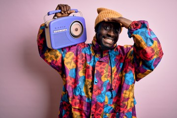 Sticker - Young african american man listening to music holding portable vintage retro radio stressed with hand on head, shocked with shame and surprise face, angry and frustrated. Fear and upset for mistake.