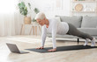 © Prostock-studio - Active Senior Woman Making Plank In Front Of Laptop At Home
