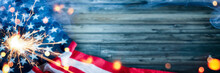 Happy 4th Of July - American Flag With Sparkler And Smoke On Wooden Background - Independence Day Celebration Concept