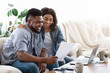 © Prostock-studio - Happy black couple managing family budget at home together