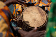 © JAMES - A closeup photo shows a drum and  hands at the kente festival in Ghana, West Africa.