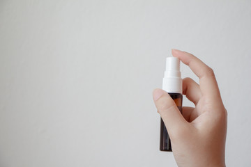 Woman holding oral spray on white background. Mouth and teeth care. Healthcare and medical concept. 