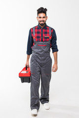 Portrait of indian man holding a red tool box isolated on white background