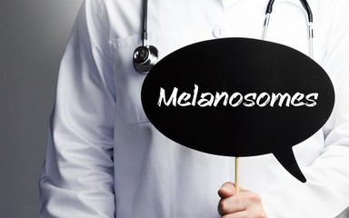 Melanosomes. Doctor in smock holds up speech bubble. The term Melanosomes is in the sign. Symbol of illness, health, medicine