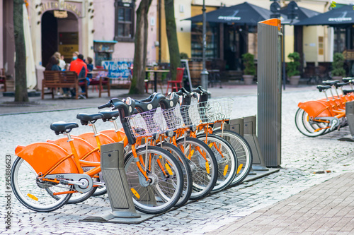 Sustainable transport. Row of bikes parked for hire in the old town, city bikes rent parking, public bicycle sharing system, bike sharing program
