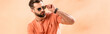 © LIGHTFIELD STUDIOS - panoramic shot of stylish young man posing in shorts, summer t-shirt and sunglasses on beige