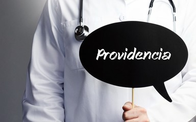 Providencia. Doctor in smock holds up speech bubble. The term Providencia is in the sign. Symbol of illness, health, medicine