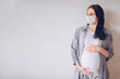 © Алина Троева - Sad pregnant woman wearing medical face masks due to illness, dizziness against infectious diseases and flu. Healthy pregnancy concept. Pregnancy And Infection. Copy space mock up. White background