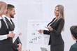© ASDF - business woman doing a presentation to his business team.