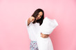 © luismolinero - Young woman in pajamas isolated on pink background points finger at you while smiling