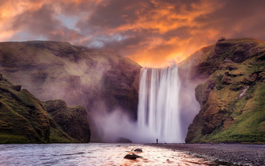 Fototapete - The Incredible landscape of Skogafoss waterfall  in North-Iceland with colorful sky during sunset. Amazing nature landscape of Iceland. Iconic location for landscape photographers. Creative Image