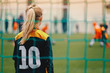 © matimix - Soccer girl playing game as a goalie. Youth female football team playing tournament match