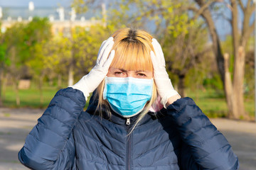 Wall Mural - Young woman with face mask on the street. Novel Chinese Coronavirus concept of self-protection