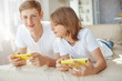 © nuzza11 - Children teenagers play a game on the phone at home.