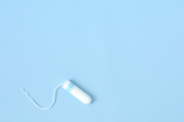 Medical female flyeng tampon on a pink background. Hygienic white tampon for women. Menstruation, means of protection.