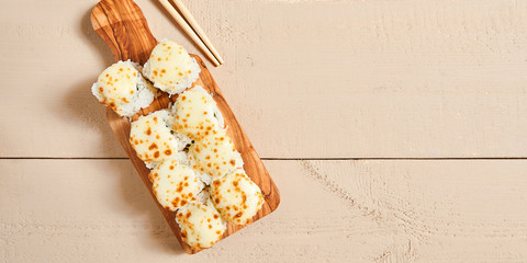 Wall Mural - Baked shrimp rolls on wooden board top view