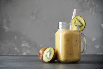 Wall Mural - Protein shake with kiwi on a concrete background. Fresh milkshake with kiwi. Smoothies.