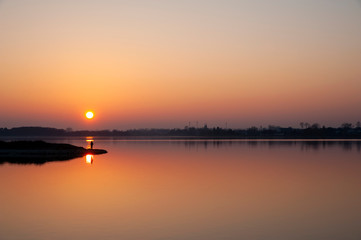 Silhouette of the angler at sunset. Lublin, Poland